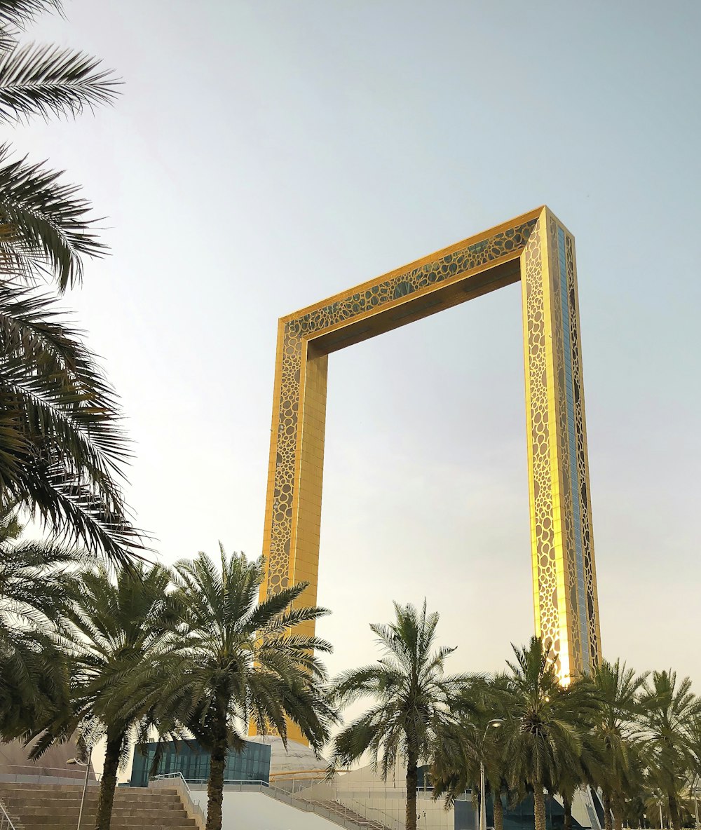 brown wooden cross with palm tree