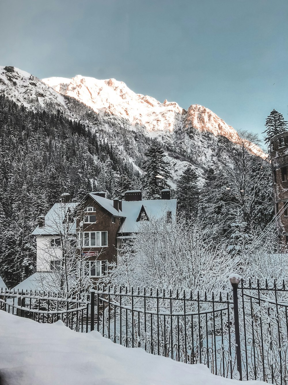 white and brown house near mountain