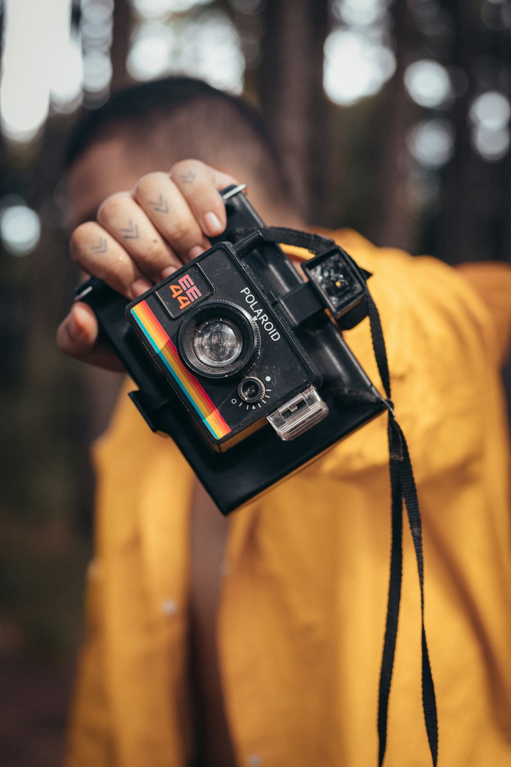 person holding black and red camera