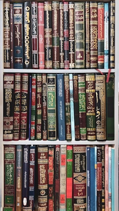 A collection of Islamic history books on a shelf.