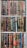 A collection of books neatly arranged on a bookshelf. The books have ornate covers with elaborate designs and texts, predominantly in Arabic script. The books are of various colors and sizes, with some having bookmarks visible.
