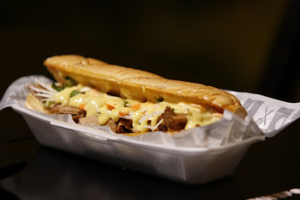 bread with cheese on white plastic container