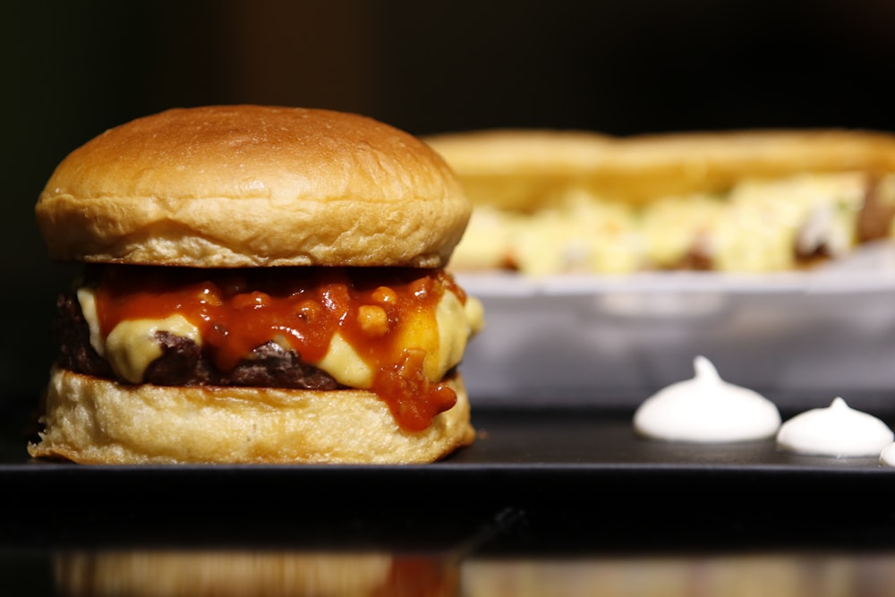 burger on black metal tray