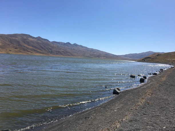 An image of a serene Great Lakes shoreline at sunrise, symbolizing steady guidance and clarity.