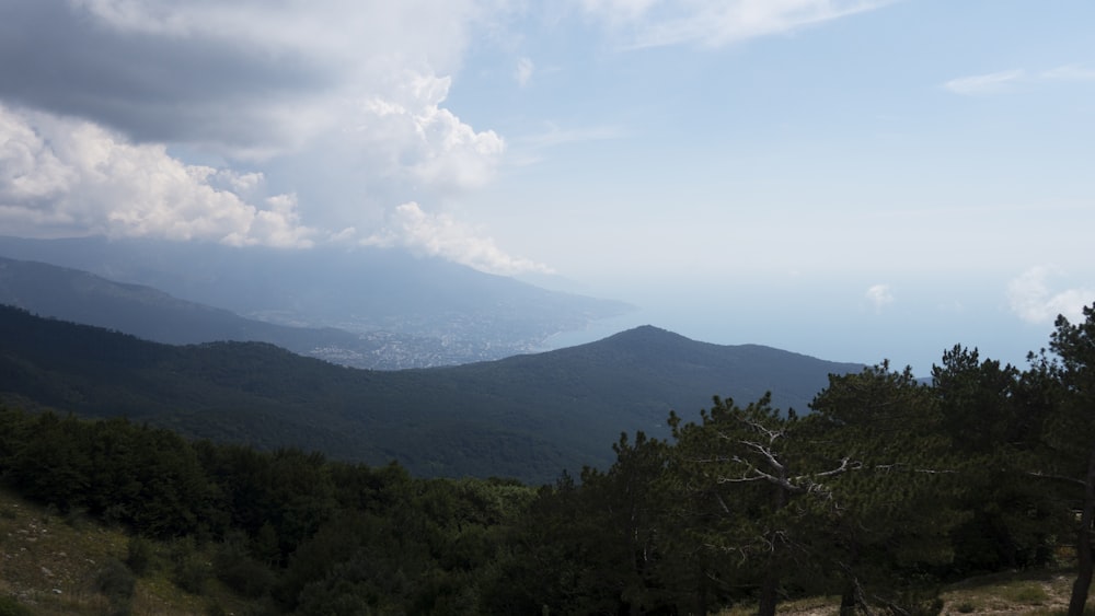 green mountain under white clouds during daytime