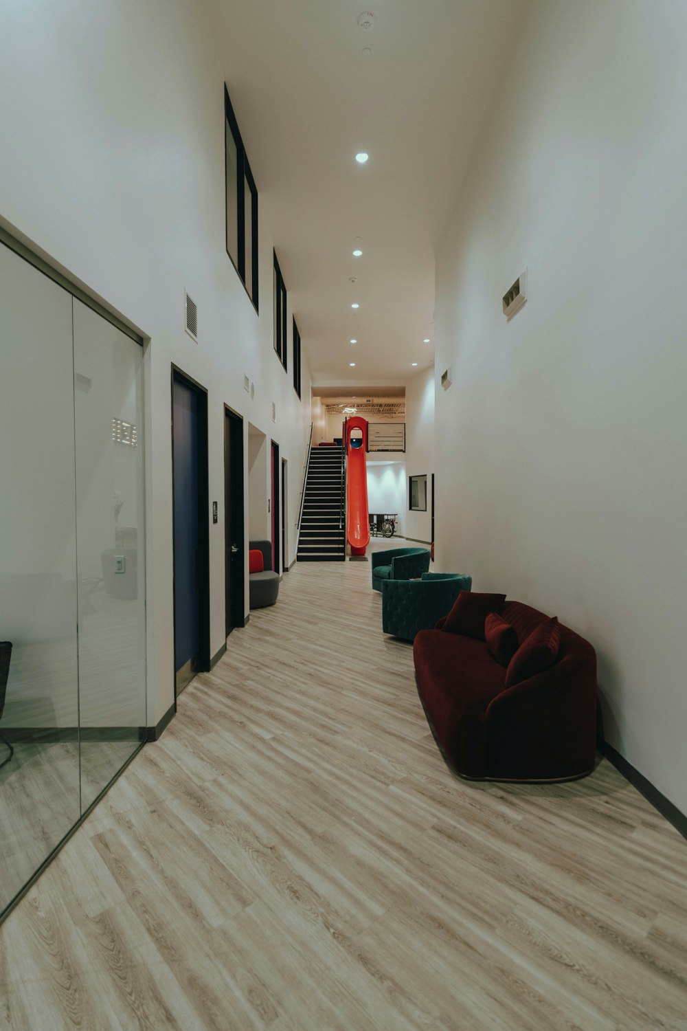 red and black sofa chair near white wall