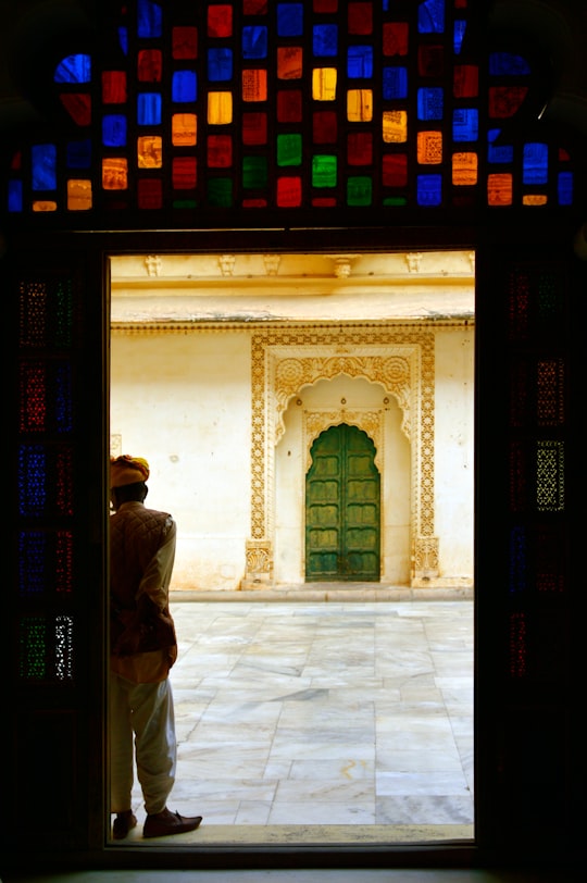 man in black jacket walking on hallway in Rajasthan India