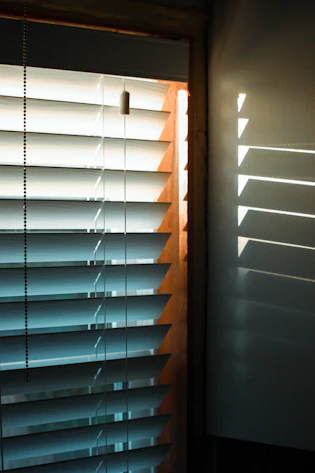 brown wooden window blinds during daytime