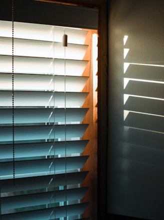 brown wooden window blinds during daytime