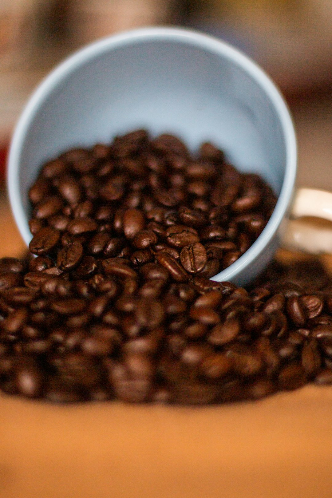 brown coffee beans in white ceramic mug