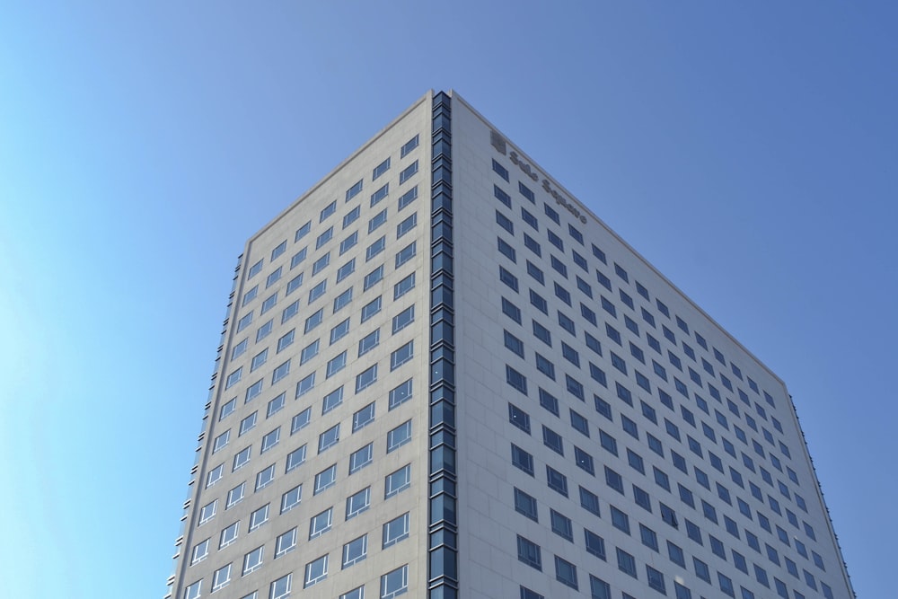 a tall white building with lots of windows