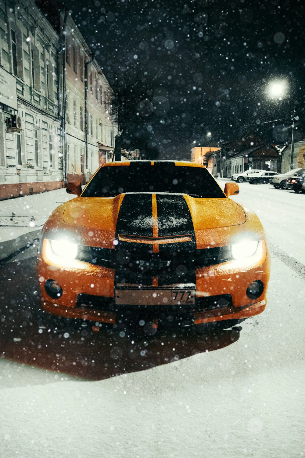 yellow car on road covered with snow during daytime