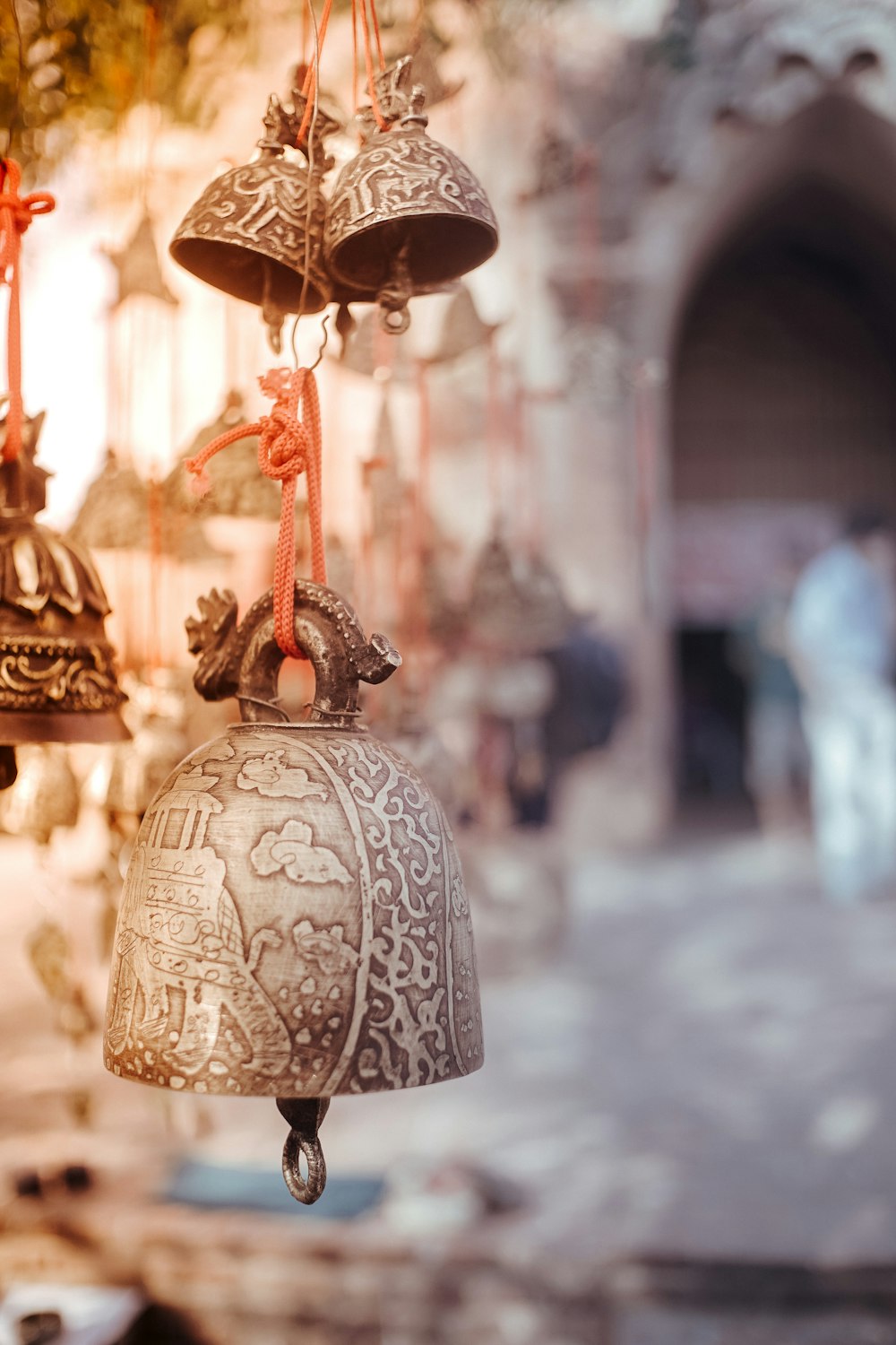 a group of bells hanging from a ceiling