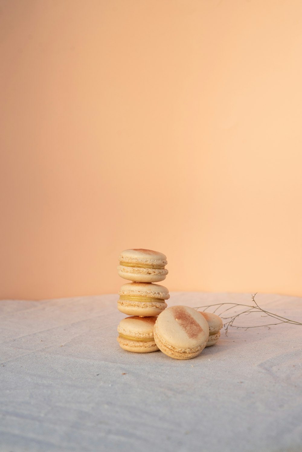 brown and white cookies on white textile