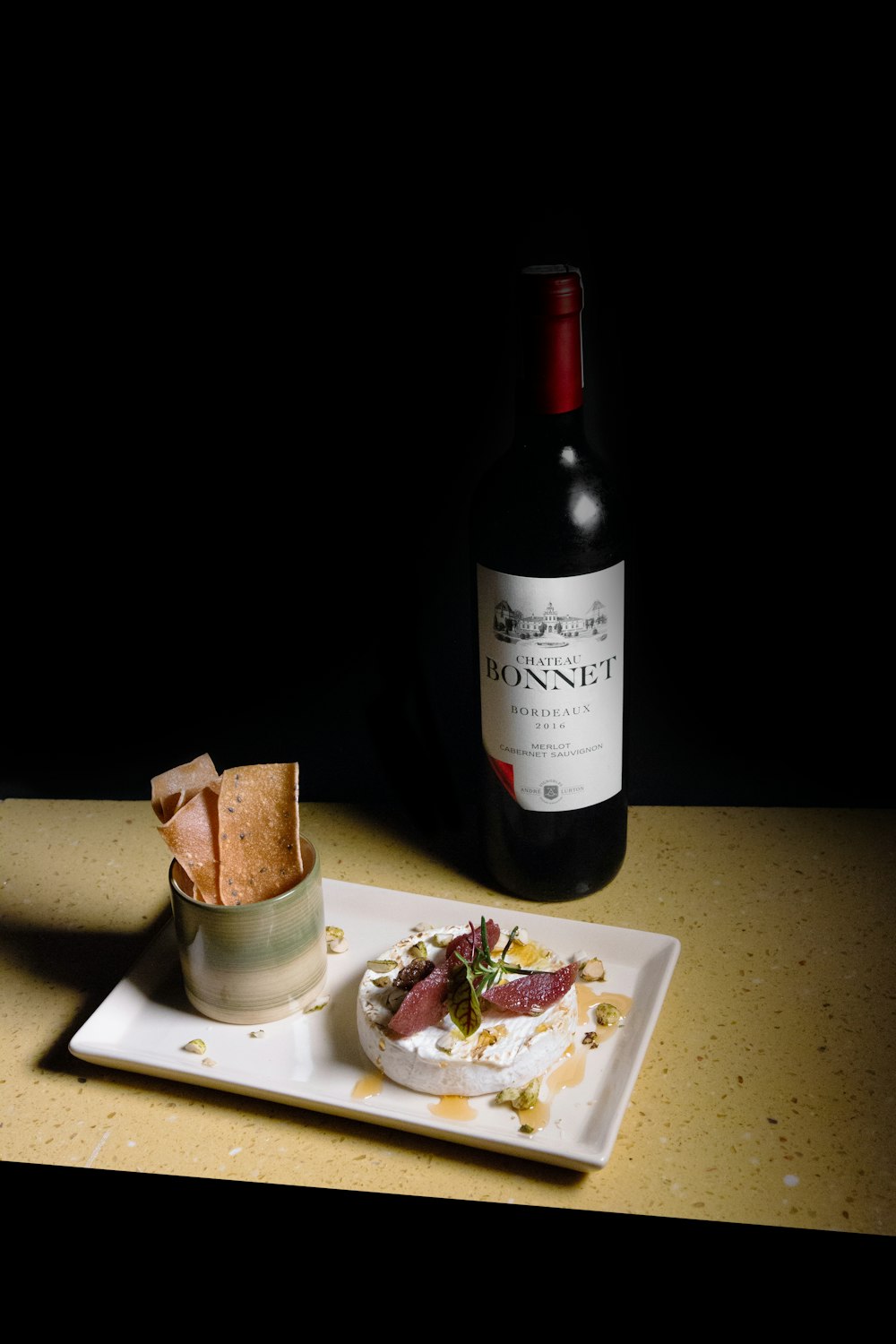 black glass bottle on white table