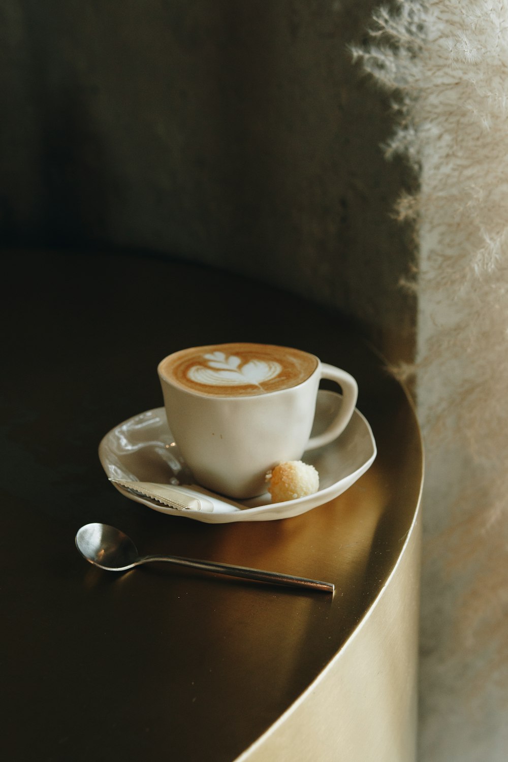 white ceramic cup on white ceramic saucer