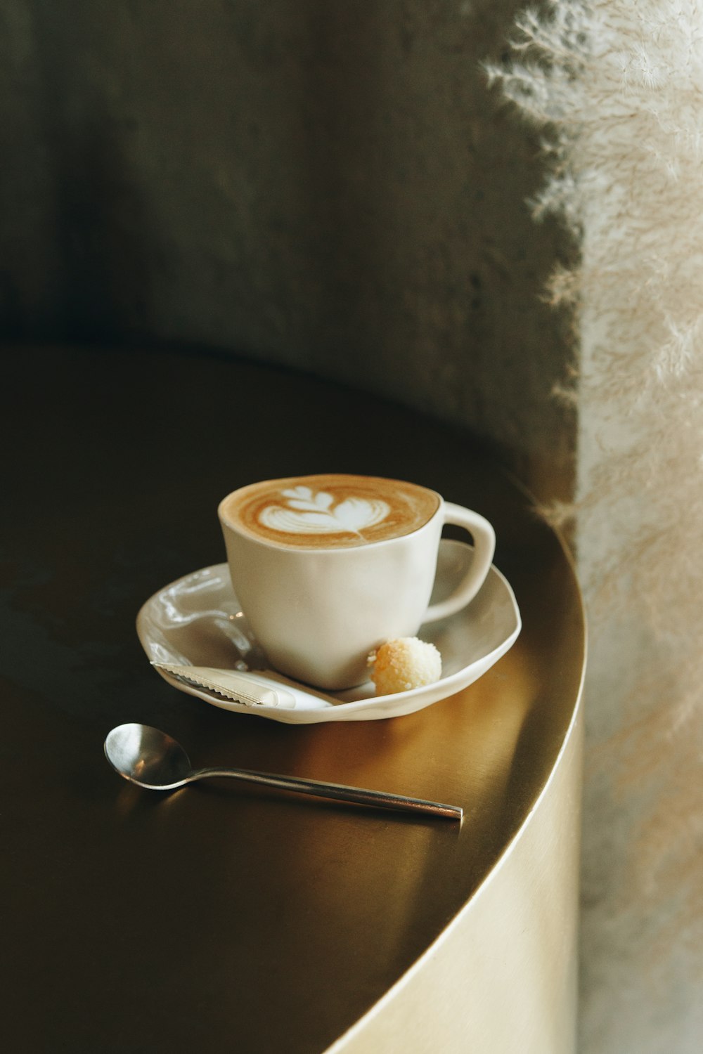 white ceramic cup on white ceramic saucer