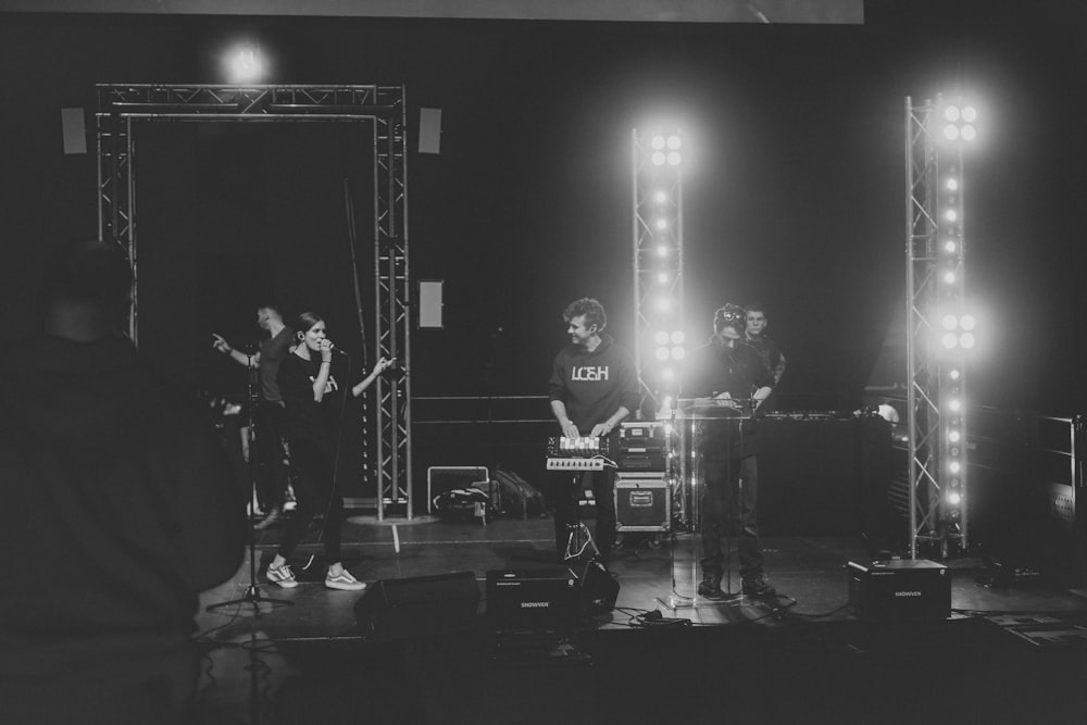 grayscale photo of band performing on stage