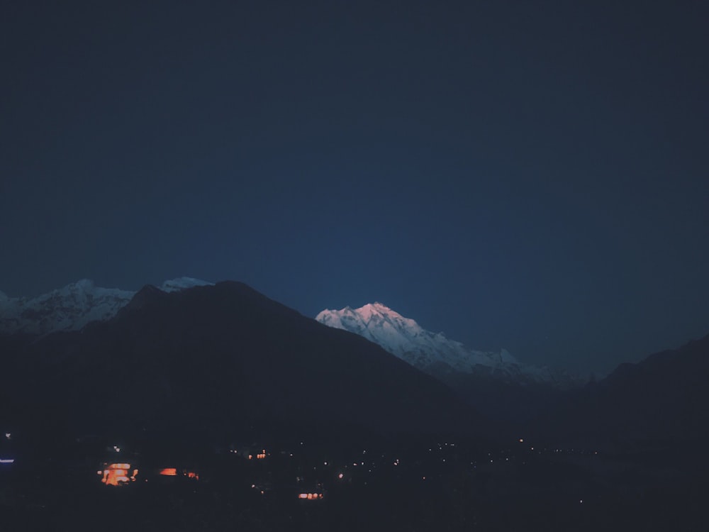 silhouette of mountain during night time