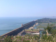 A panoramic view of the Itaipu Dam under a clear blue sky, showcasing its massive structure.