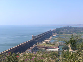 A panoramic view of the Itaipu Dam under a clear blue sky, showcasing its massive structure.