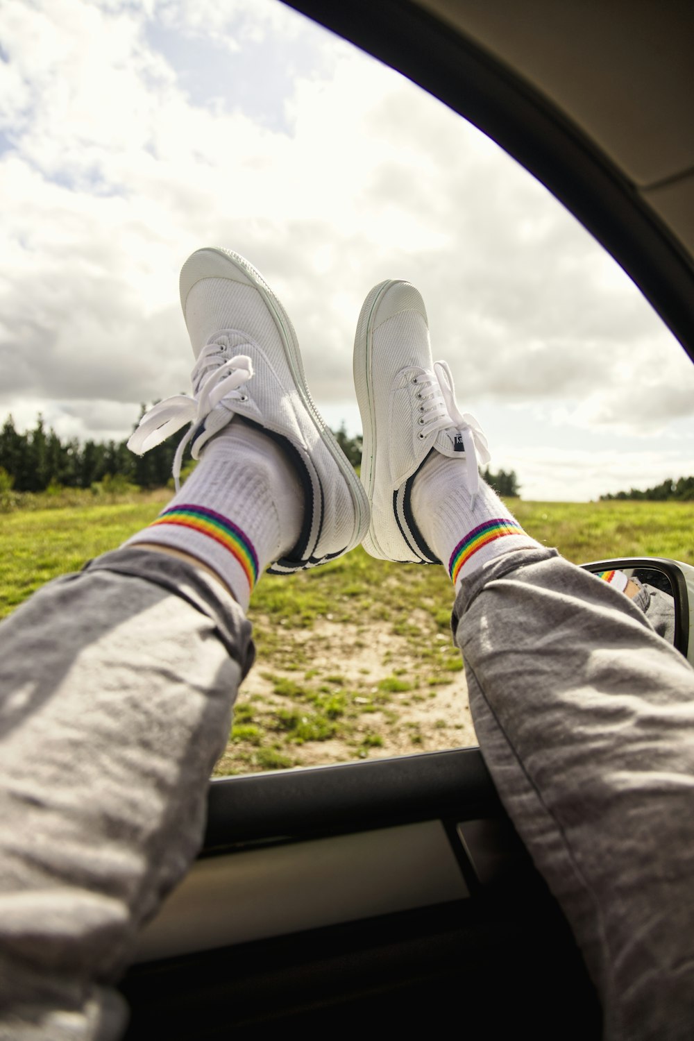 person in gray pants and gray nike sneakers