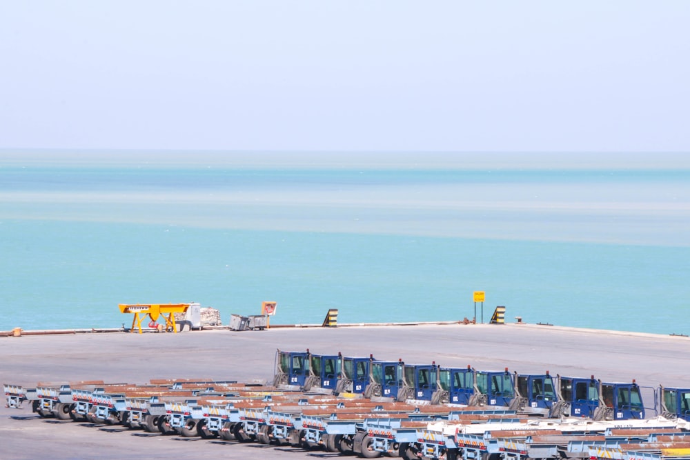 cars parked on parking lot near sea during daytime