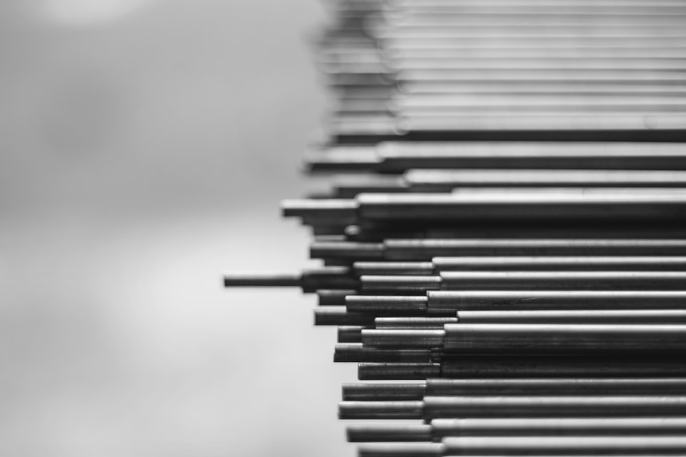 grayscale photo of stack of books