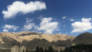 A panoramic view of mountains under a clear blue sky.
