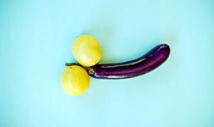 yellow lemon fruit beside yellow round fruit