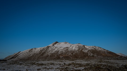 brown and white mountain under blue sky during daytime in Þorbjörn Iceland
