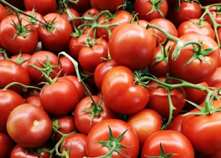 red tomatoes on brown wooden table