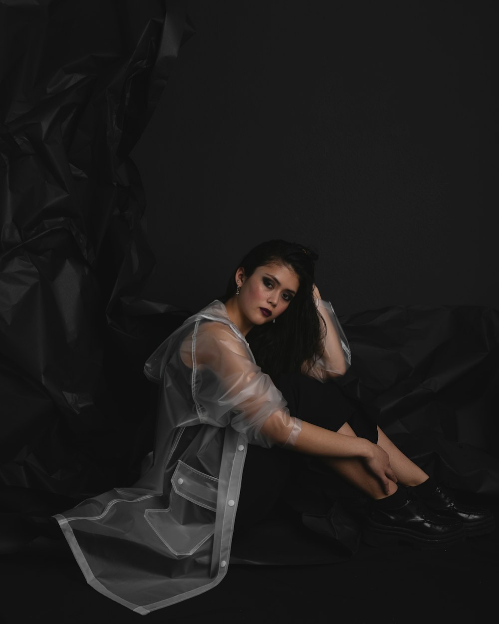 woman in white dress sitting on black textile
