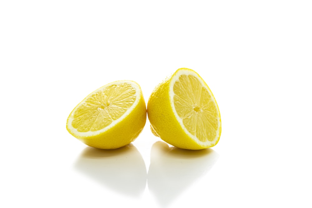 2 yellow lemon on white surface