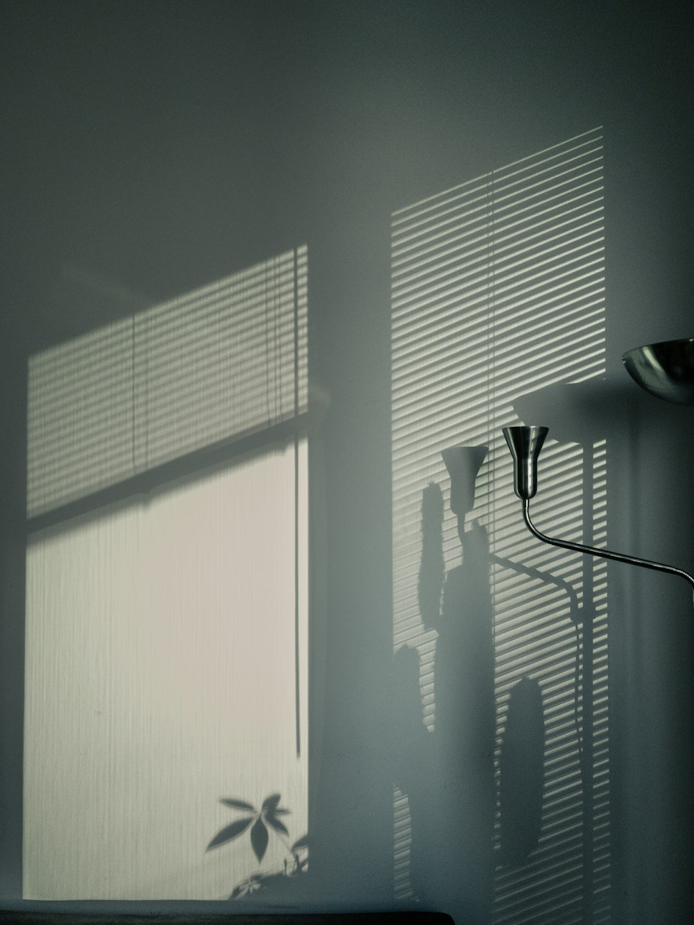 white window blinds near black and white floor lamp