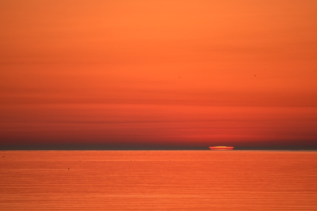 body of water during sunset