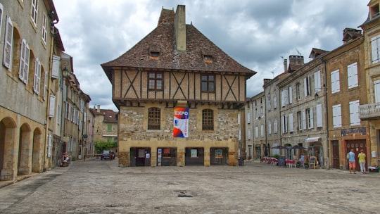 brown concrete building under white clouds during daytime in Saint-Céré France