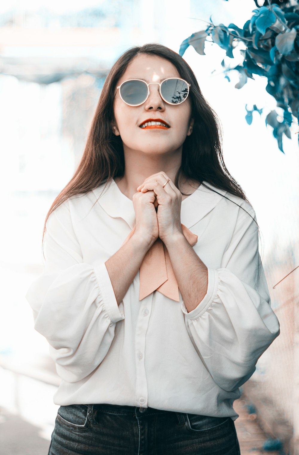 woman in white long sleeve shirt wearing sunglasses