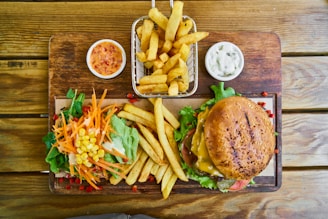 fries and burger on brown wooden tray