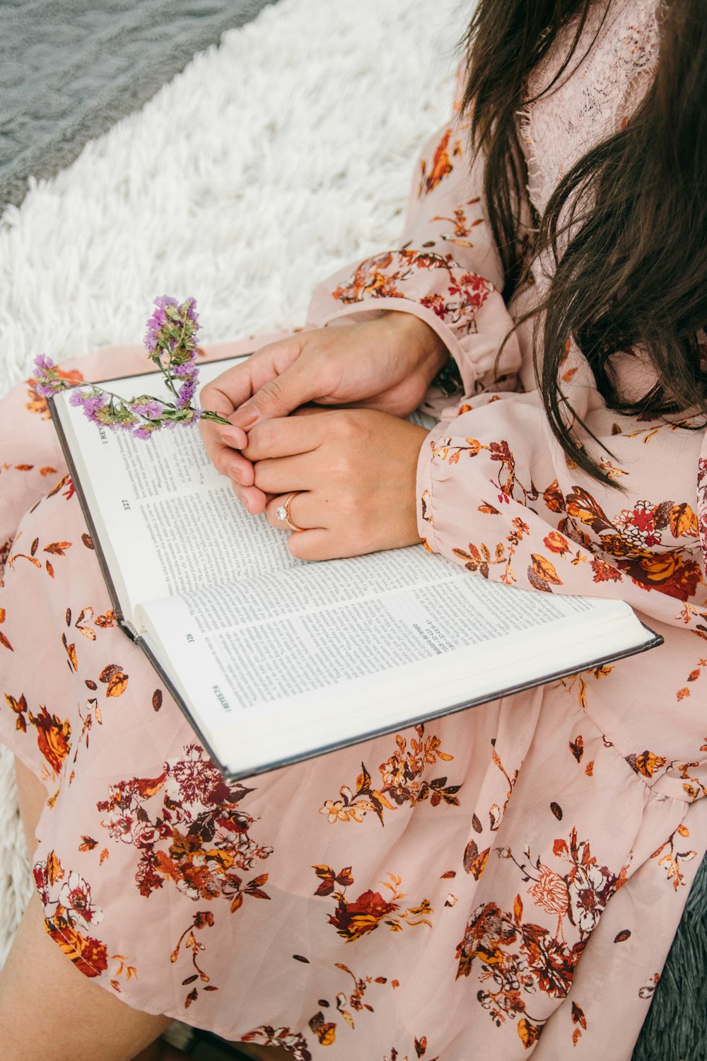 woman in white and brown floral long sleeve shirt using white laptop computer