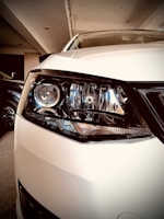 Close-up of an automobile headlight bulb replacement, showcasing detailed care.