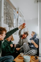 woman in black and white checkered long sleeve shirt sitting beside man in green crew neck