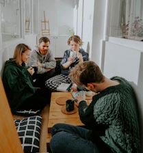 A bright, welcoming shared home with people enjoying a relaxed afternoon together.