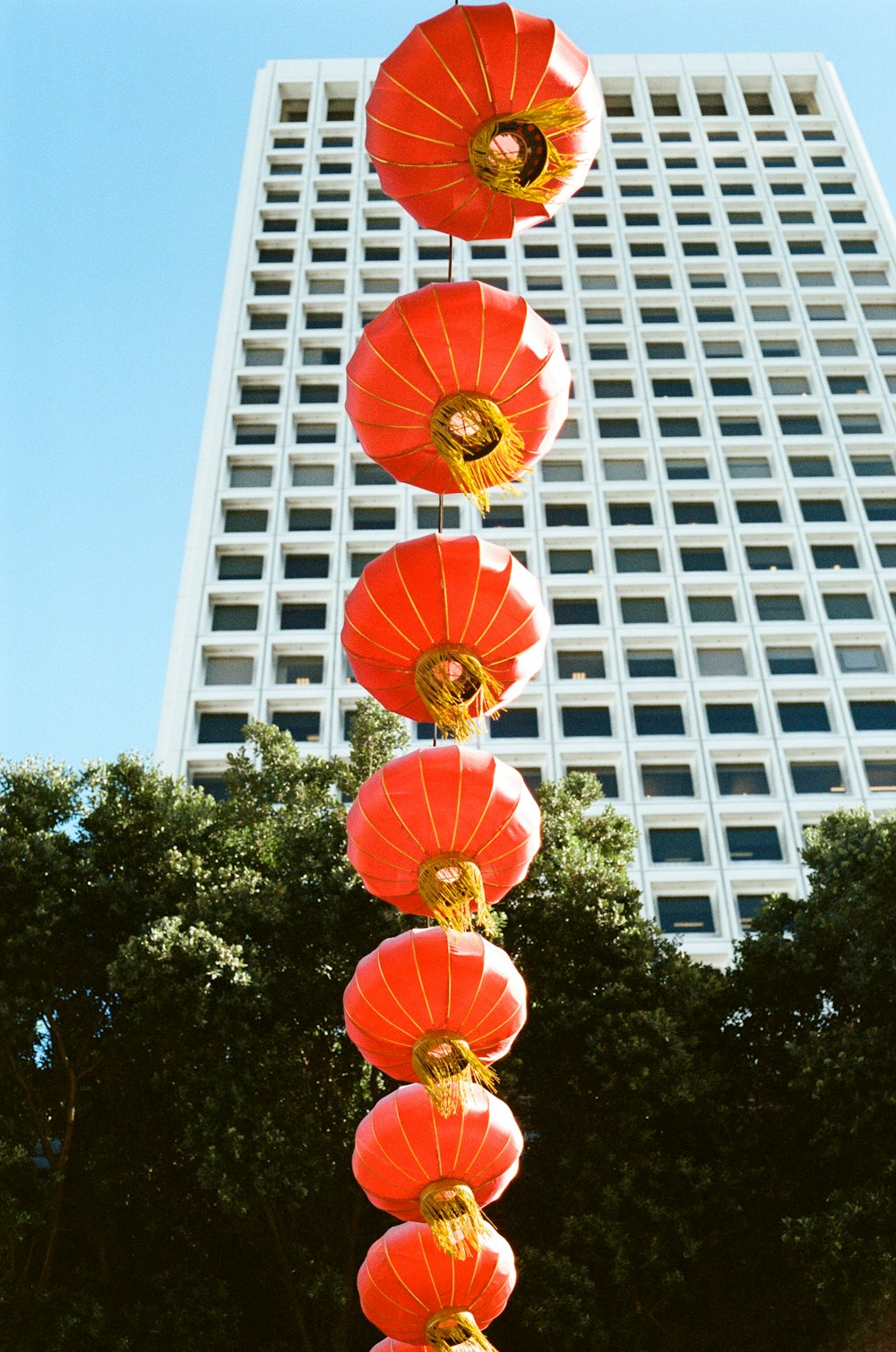 red and yellow umbrella near white concrete building