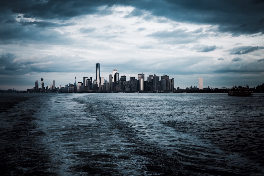 city skyline across body of water during daytime