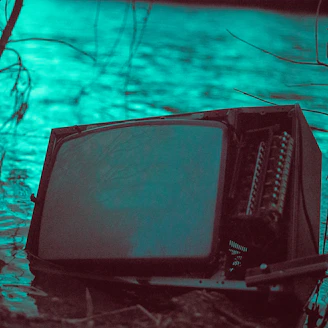 black crt tv on snow covered ground
