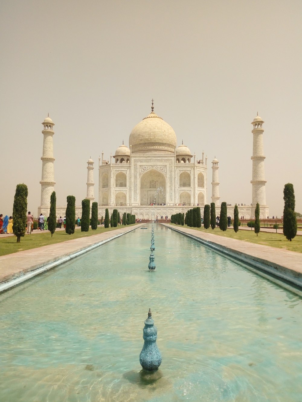 a large white building with a fountain in front of it