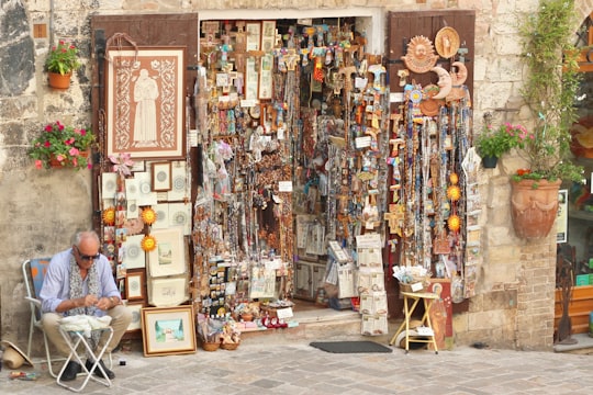 assorted wall decors on brown wooden wall in Assisi Italy