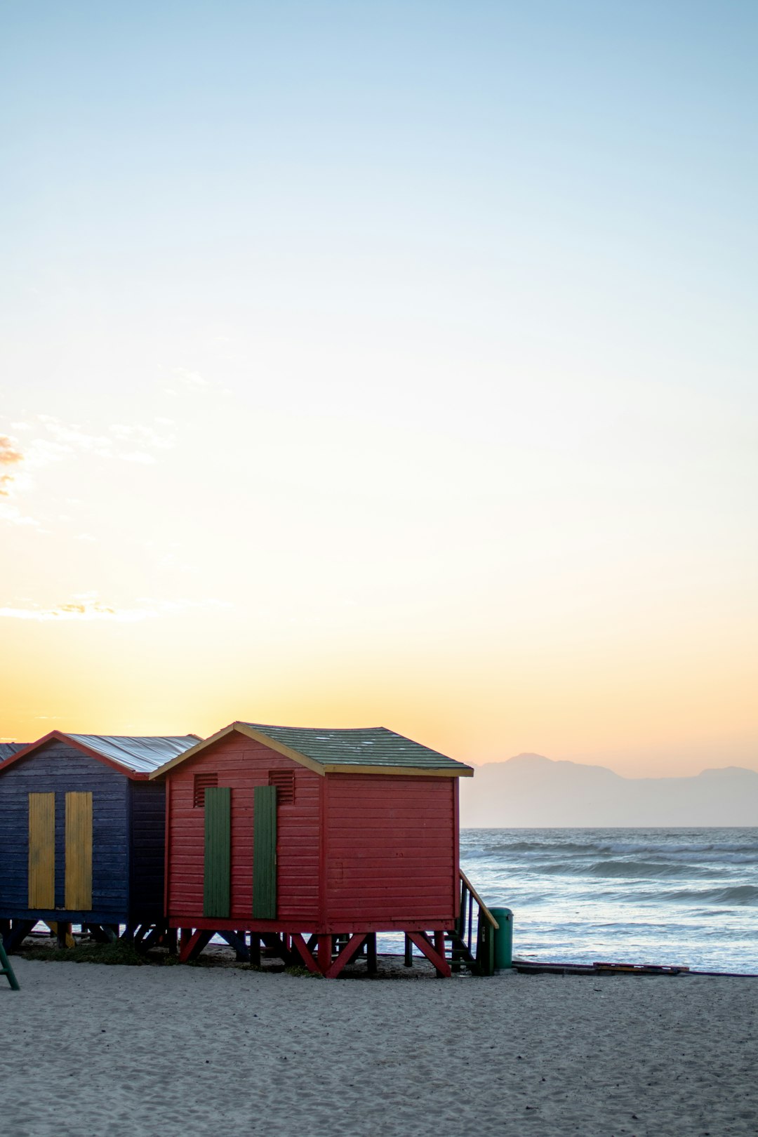 brown wooden house on sea shore during daytime