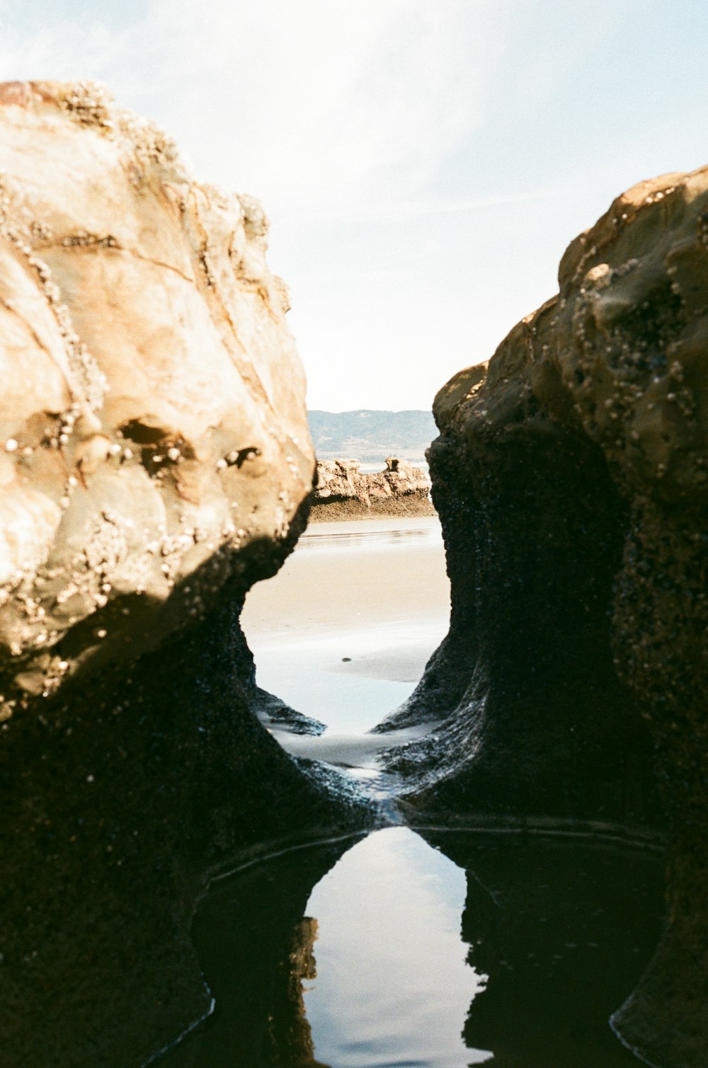 brown rock formation near body of water during daytime